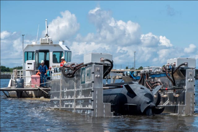 HII’s Pharos prototype platform being towed behind a small craft in the Pascagoula River while recovering HII’s Proteus LDUUV during a demonstration