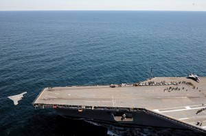 An X-47B Unmanned Combat Air System (UCAS) demonstrator launches from the aircraft carrier flight deck 