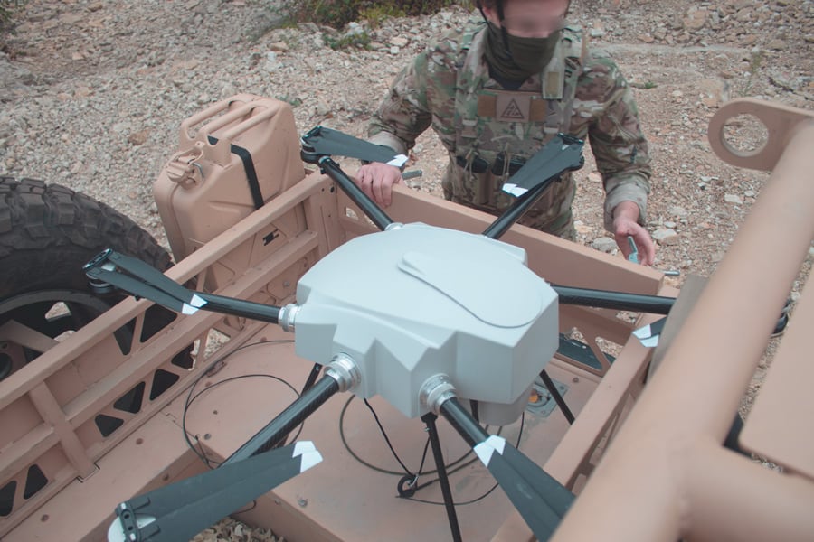 Vehicle mounted surveillance tethered drone