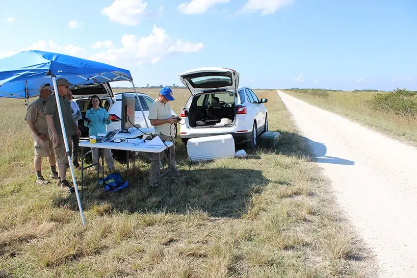 Joseph Cerreta and other members of the ERAU team sets up the ground control station along a levee in South Florida.