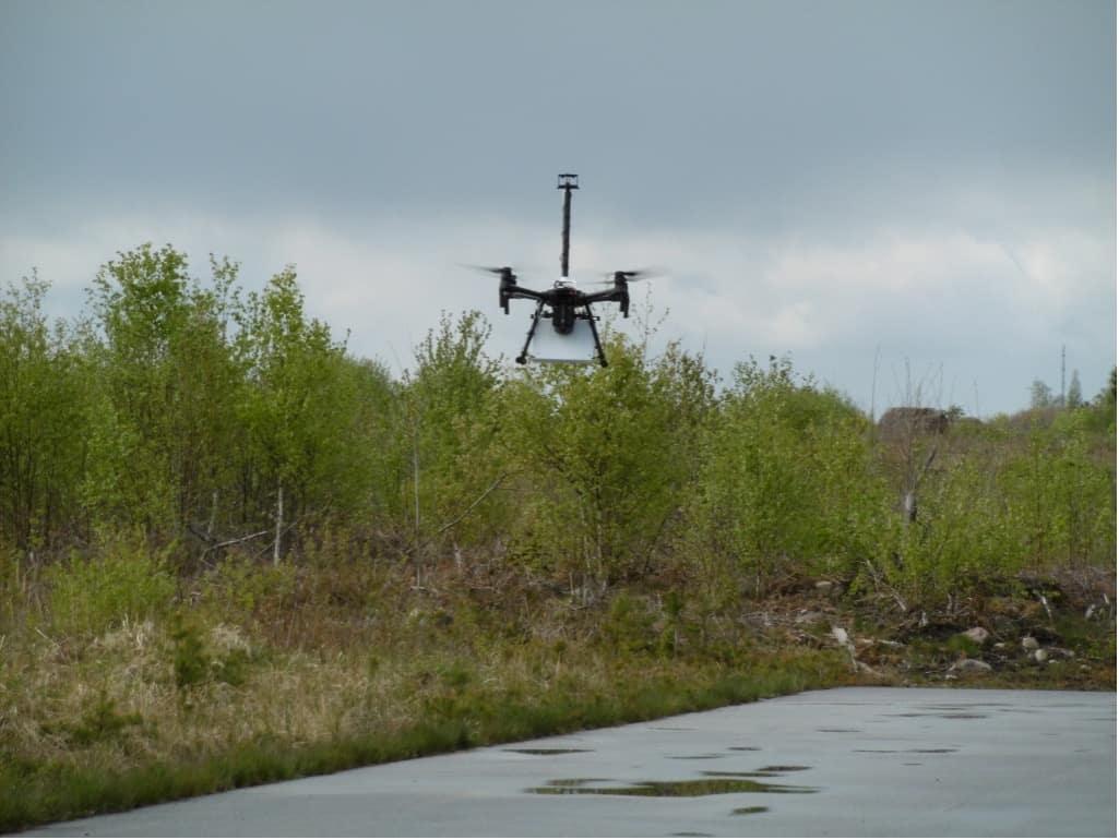 quadcopter hovering with the white Aeris sensor attached underneath The image shows a quadcopter hovering with the white Aeris sensor attached underneath. The quadcopter also carries a Sparvio sensor system that synchronizes data from Aeris with readings from the TriSonica Wind & Weather Sensor, GPS and other sensors. Sparvio logs all data and transmits it to a ground station to visualize on a map in real-time. In the end, the combination of all data will be used to calculate not only the location of methane emission sources, but also the quantity of gas flow.