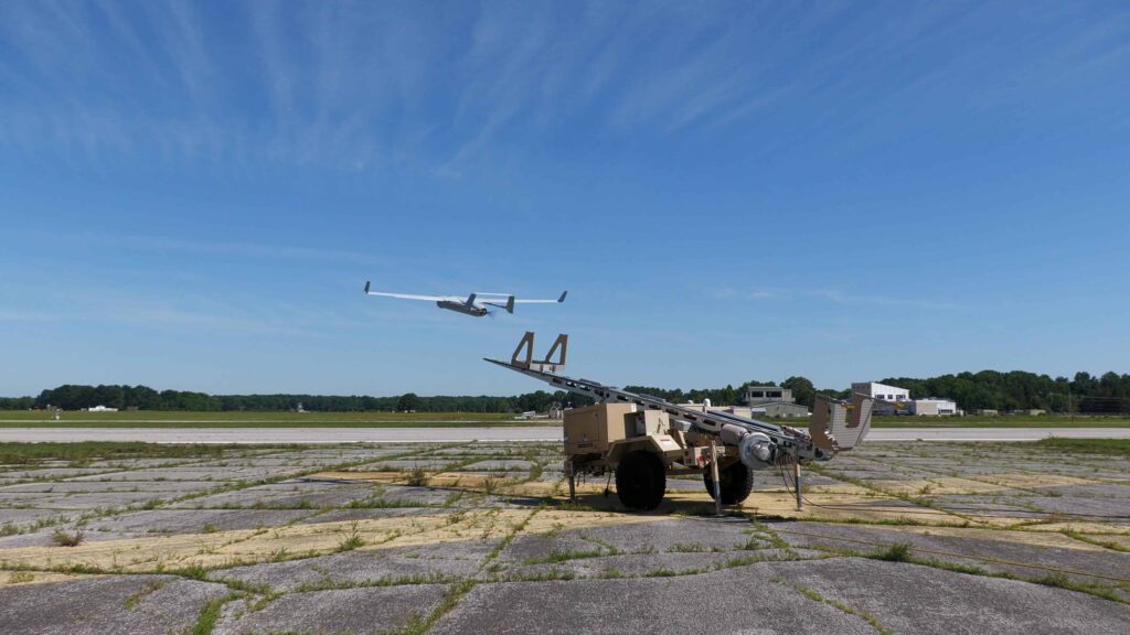 An RQ-21 Blackjack launches over an airfield at Naval Air Station Patuxent River to support the first flight test of Guardian