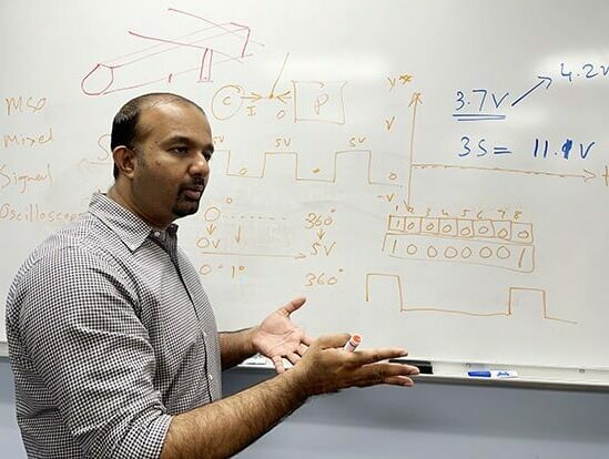 Sai Sanker lectures students in the new robotics lab.