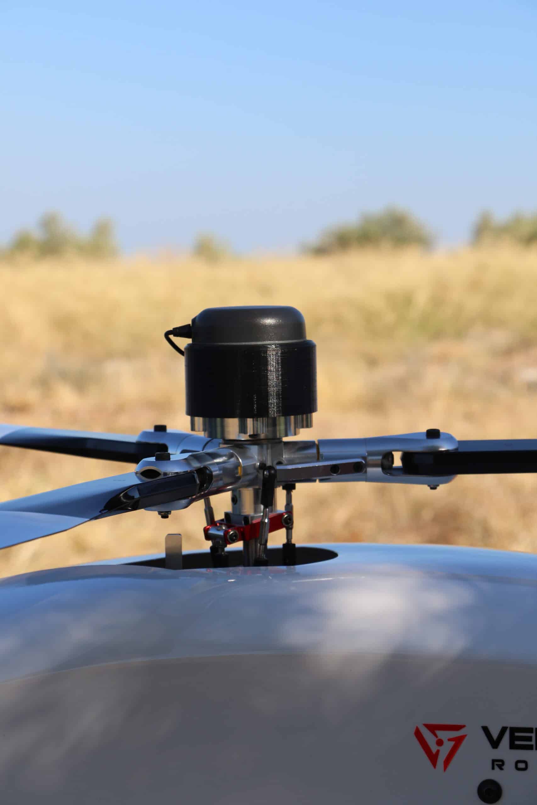 Unmanned helicopter with payload over rotor