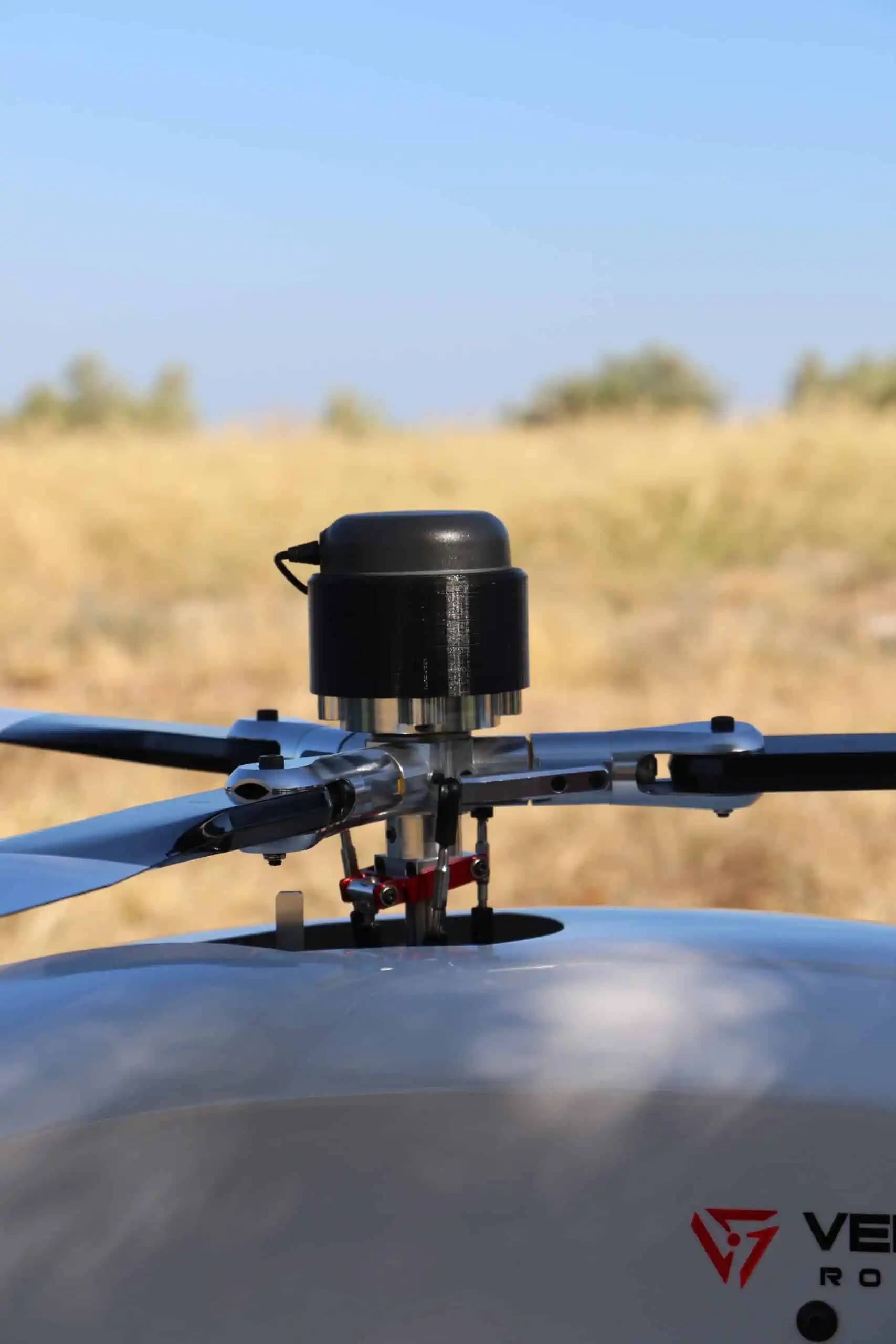 Unmanned helicopter with payload over rotor