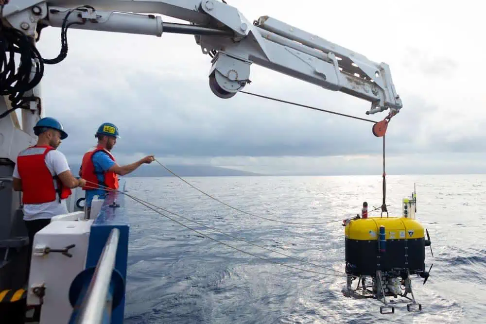mesobot-team-members-deploy-the-vehicle-over-the-edge-of-the-ev-nautilus-credit-ocean-exploration-trustmarley-parker