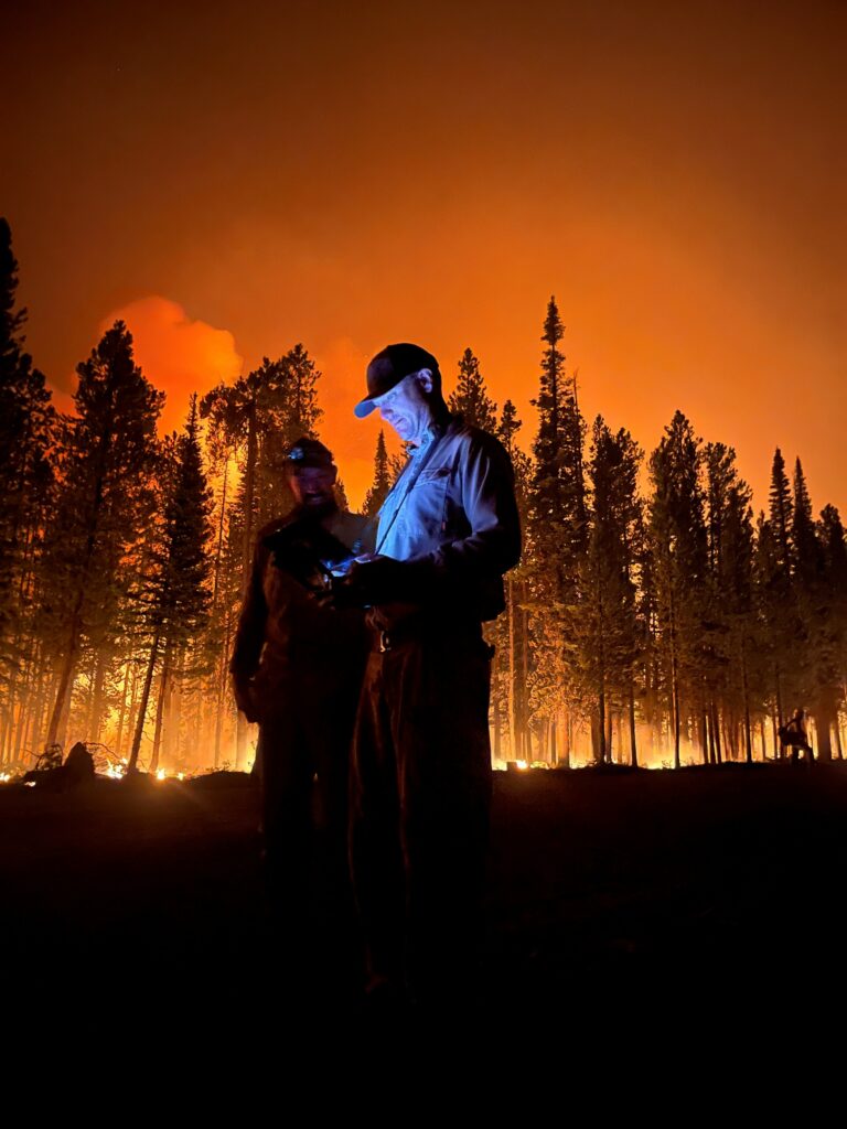 Two Forest Service UAS Pilots providing direct support to on the ground crews during active suppression operations.