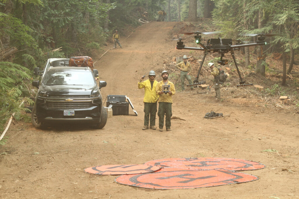UAS Pilots launching a UAS to support crews with infrared flights. Photo Credit: Mike McMillan/USFS